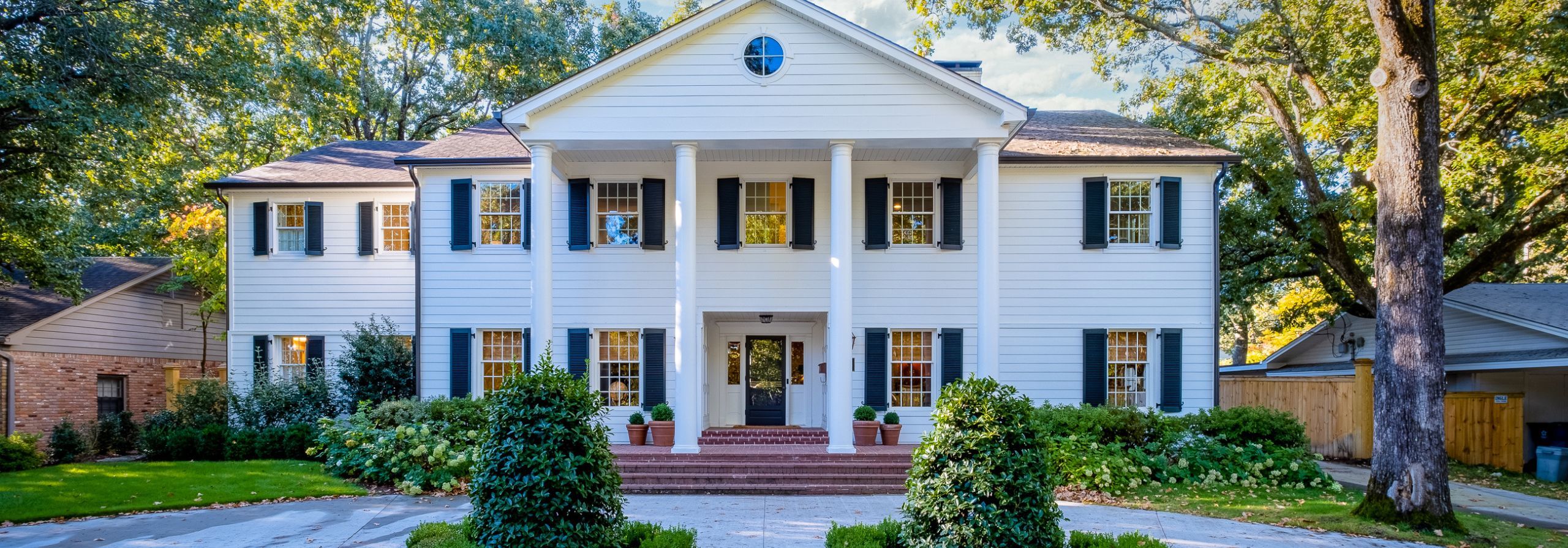 Large home with white columns in front standing tall